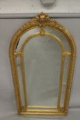 A GOOD LARGE GILT FRAMED VICTORIAN STYLE ARCH TOP MIRROR. 7ft 4ins x 3ft 8ins wide.