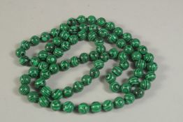 A MALACHITE BEAD NECKLACE. 88cms long.