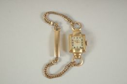 A LADIES GOLD COCKTAIL WATCH with 14k gold filled case and matching strap.