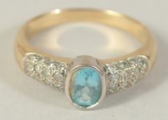 A 9CT GOLD BLUE TOPAZ AND DIAMOND RING.