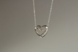 A WHITE GOLD AND DIAMOND HEART SHAPED PENDANT AND CHAIN.