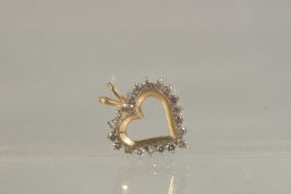 A GOLD AND DIAMOND HEART SHAPED PENDANT.