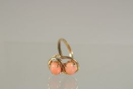 A GOLD DOUBLE CORAL CROSSOVER RING.