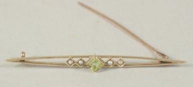 AN EDWARDIAN PERIDOT AND NATURAL PEARL BAR BROOCH.