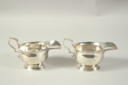 A HEAVY PAIR OF SILVER SAUCEBOATS by THE GOLDSMITH & SILVERSMITH CO. London 1958. Weight: 14ozs.