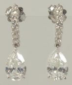 A SUPERB PAIR OF PEAR SHAPED DIAMOND DROP EAR RINGS. 2.05 and 2.09 carat. Colour f. V S Z. The