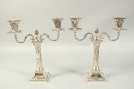 A GOOD PAIR OF TWO BRANCH SILVER CANDLESTICKS with coloums on square bases. 12ins high. London