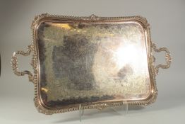 A LARGE PLATE TWO-HANDLED TEA TRAY with gadrooned and shell borders, and scroll handles. 30ins