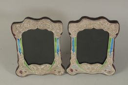 A PAIR OF ART DECO DESIGN SILVER AND BLUE ENAMEL BUTTERFLY PHOTOGRAPH FRAMES. 8 x 6ins.