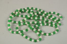 A STRING OF JADE AND PEARLS with 14ct gold clasp. 120cms long.