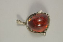 A SILVER AND AMBER PENDANT.