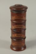 A WOODEN SPICE TOWER, cloves. ginger, mace and nutmeg. 8ins high.