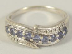 A 9CT GOLD TANZANITE AND DIAMOND BAND RING