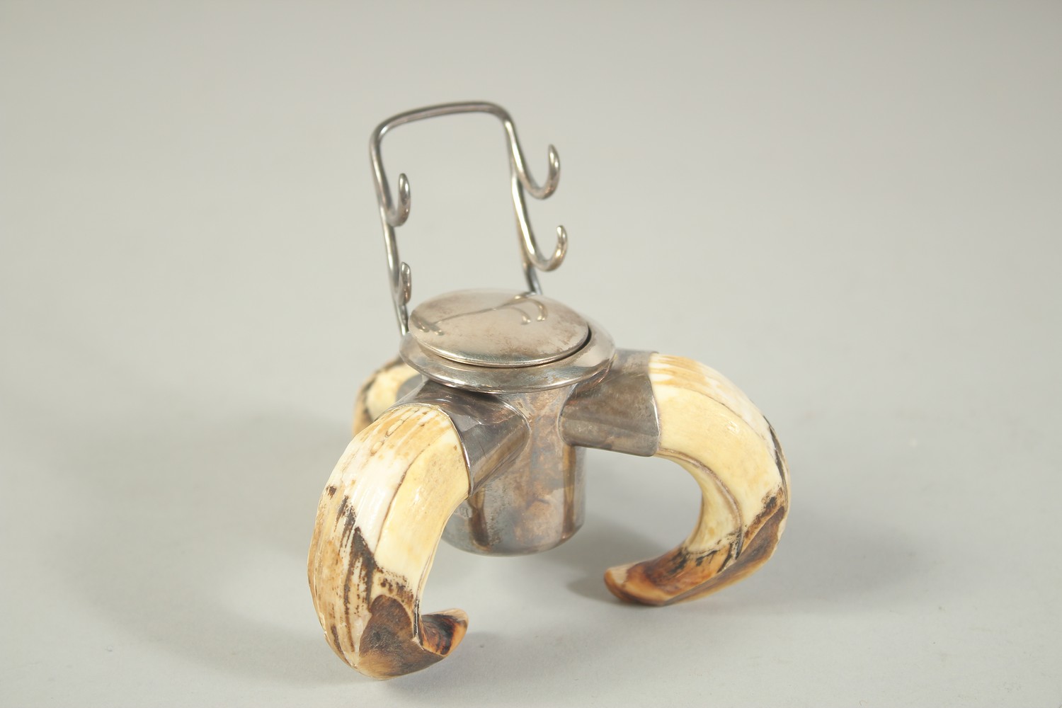 A SILVER MOUNTED BOAR'S TUSK INKWELL London 1910.
