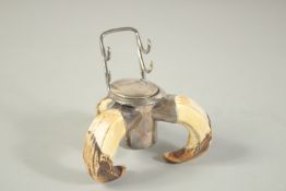 A SILVER MOUNTED BOAR'S TUSK INKWELL London 1910.