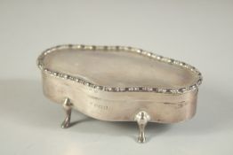 AN OVAL SILVER JEWELLERY BOX with velvet interior on four pad feet. 4ins long. Birmingham 1916.