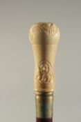 A CARVED BONE HANDLED WALKING STICK 