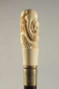 A CARVED BONE HANDLED WALKING STICK 