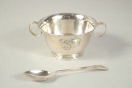 A TWO HANDLED CIRCULAR SILVER PORINGER SPOON in a fitted case. Sheffield 1924.