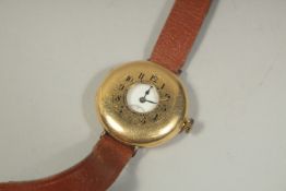 A GENTLEMAN'S 18CT GOLD HALF HUNTER WRIST WATCH on a leather strap.