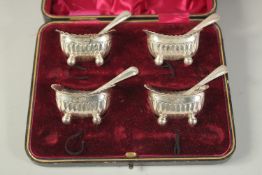 A SET OF FOUR SILVER BOAT SHAPE SALTS. Sheffield 1906 and four spoons, 1904. (8).