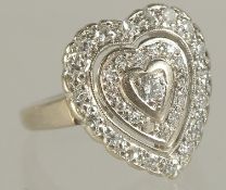 A GOLD DIAMOND HEART SHAPED CLUSTER RING.