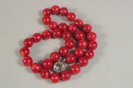 A STRING OF RED BEADS. 42cms long.