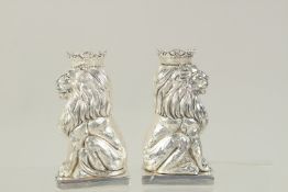 A PAIR OF SILVER PLATED ROYAL LIONS SALT AND PEPPERS. 3.25