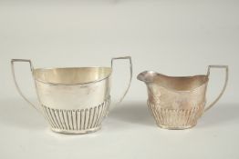 A TWO HANDLED SILVER SUGAR BASIN AND MILK JUG. Birmingham 1959. Weight: 5ozs.