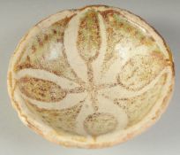 A RARE SMALL 9TH-10TH CENTURY MESOPOTAMIAN ABBASID COPPER LUSTRE GLAZED POTTERY BOWL, 9cm wide.