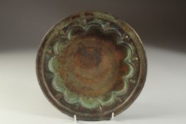 A FINE 13TH CENTURY PERSIAN SELJUK ENGRAVED BRASS DISH, depicting a mythical creature in the