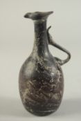 A RARE EARLY ISLAMIC OR POSSIBLY ROMAN AUBERGINE GLASS JUG, 16cm high.