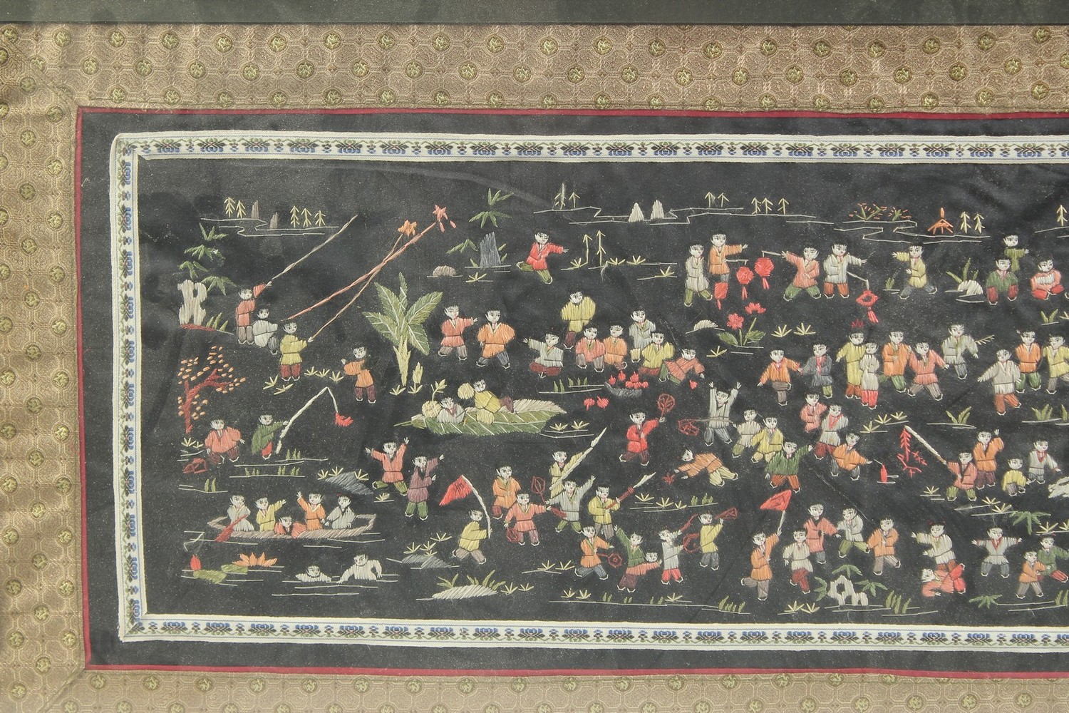 A CHINESE EMBROIDERED SILK 'HUNDRED BOYS' TEXTILE, framed and glazed, textile 31.5cm x 65cm. - Image 2 of 3