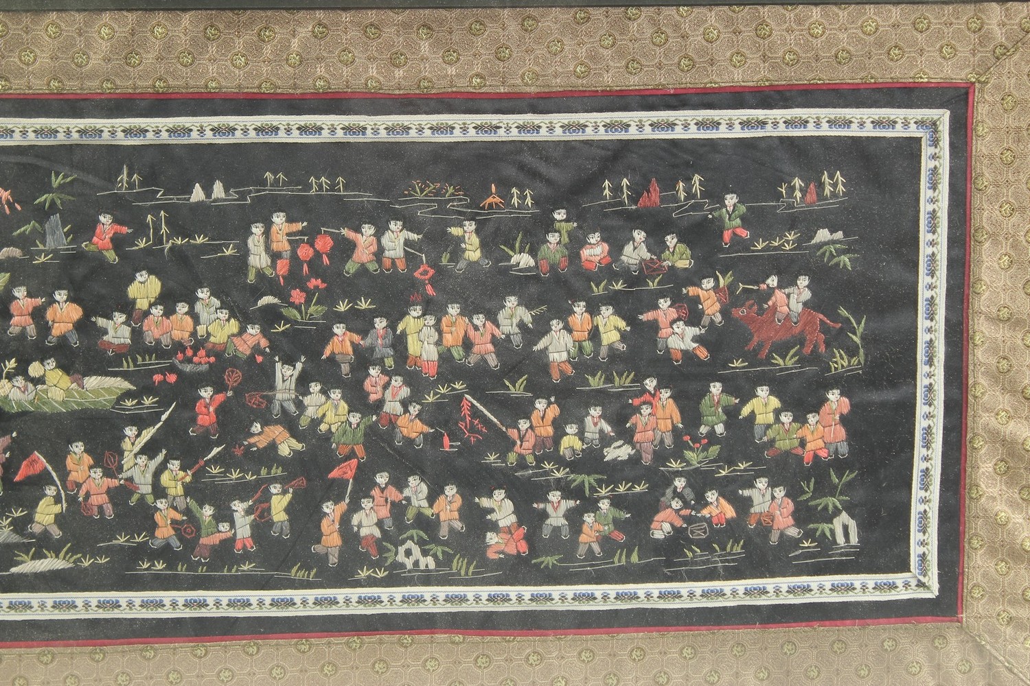 A CHINESE EMBROIDERED SILK 'HUNDRED BOYS' TEXTILE, framed and glazed, textile 31.5cm x 65cm. - Image 3 of 3