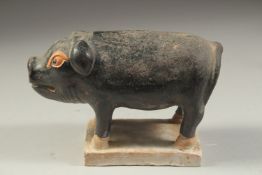 A CHINESE TOMB SACRIFICE POTTERY FIGURE OF A PIG, possibly Han Dynasty, 16cm long.