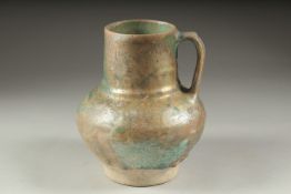 A RARE 12TH CENTURY PERSIAN KASHAN TURQUOISE GLAZED JUG, with traces of iridescence, 19cm high.