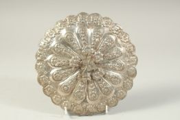 AN OTTOMAN EMBOSSED SILVER MIRROR, with bird shape finial, 19.5cm wide.