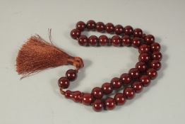 A SET OF CHERRY AMBER-TYPE PRAYER BEADS.