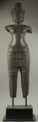 A FINE AND LARGE CAMBODIAN KHMER OR KHMER STYLE CARVED BLACK STONE FIGURE OF A MALE DEITY, raised on