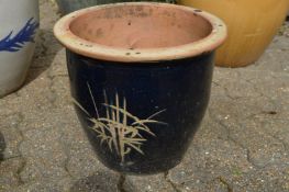 A pair of large glazed planters.