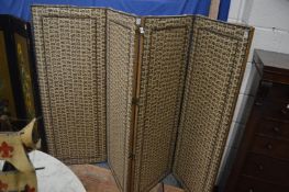 A brass close-nailed and upholstered four panel folding dressing screen.