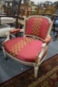 Decoratively upholstered and painted low armchair.