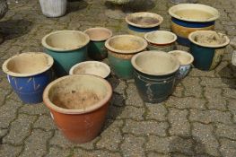 A quantity of glazed plant pots.