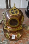 A miniature copper and brass divers helmet.