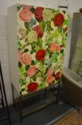 A stylish free standing two door cabinet, the pair of lacquered doors decorated with roses supported