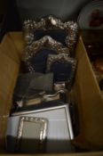 Various silver and other photograph frames.