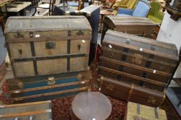 Four various large trunks.