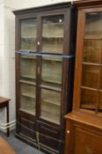 A large grained pine four door bookcase.