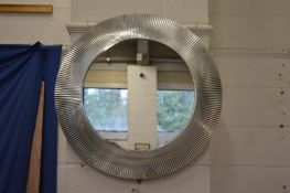 A stylish circular mirror.