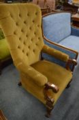 A Victorian mahogany framed and button upholstered open armchair.